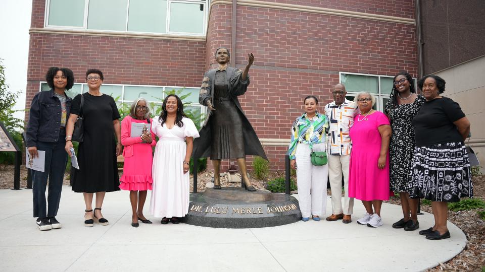 Dr. Johnson’s family gathered around a statue of her likeness.