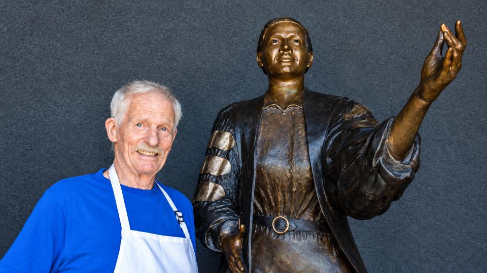 Steve Maxon stands next to the statue he created of Dr. Johnson.