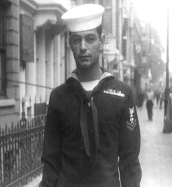Ernest Nicholas walking down the street in his Navy uniform