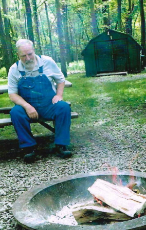 photo of George Marple sitting in front of a fire