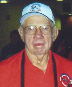 Gerald Milder years later wearing a white hat and red polo
