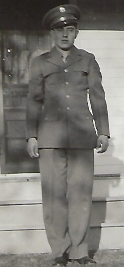 John Weno standing in front of a house wearing his Army uniform