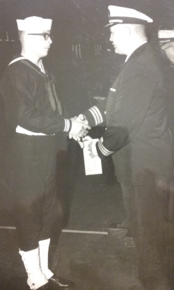 Lawrence Jones shaking hands with a fellow Navy man