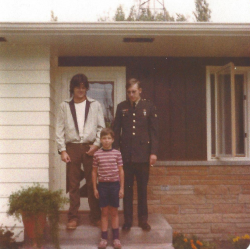 Phil Barnes standing in front of his house with his brothers
