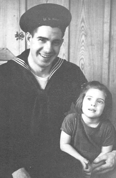Raymond O'brien sitting in his Navy uniform next to a little girl possible his sister