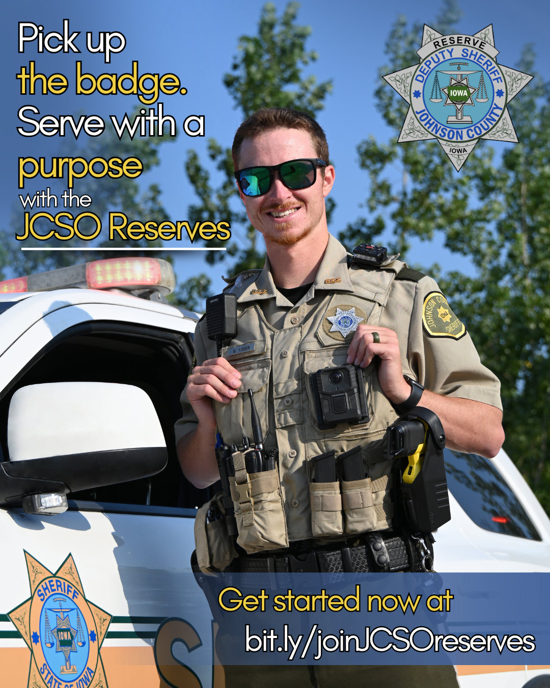 A Johnson County Sheriff's Office Reserve Deputy stands smiling in his uniform in front of his patrol car. Pick Up the Badge. Serve with a purpose with the JCSO Reserves.