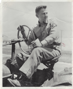 Donald Rockway sitting on a trackor in his military uniform