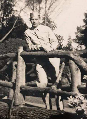 Photo of Russell Phillips in uniform standing on a bridge