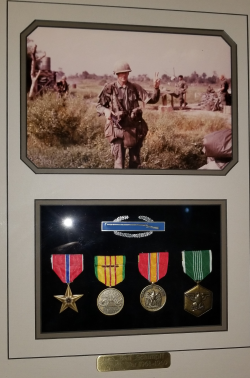 Benson Schimpff's plaque with his military photo on top and his awards/metals on the bottom