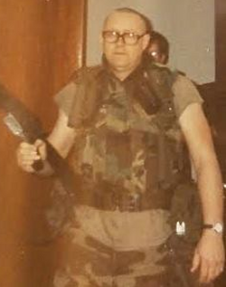 Steve McCann wearing his military gear holding a rifle
