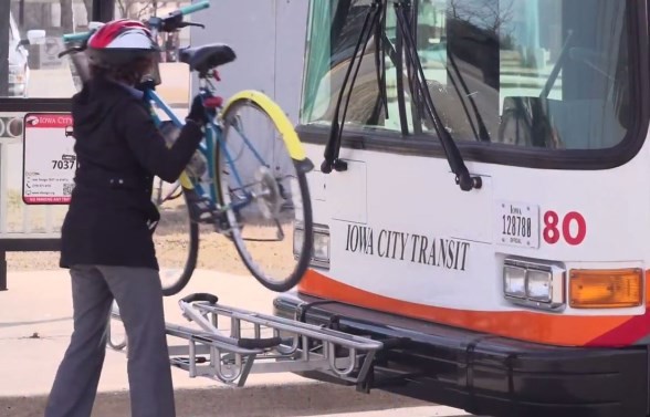 Citizen putting a bike on the city bus