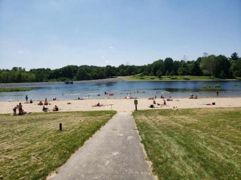 A busy Kent Park Beach on a warm and sunny day.